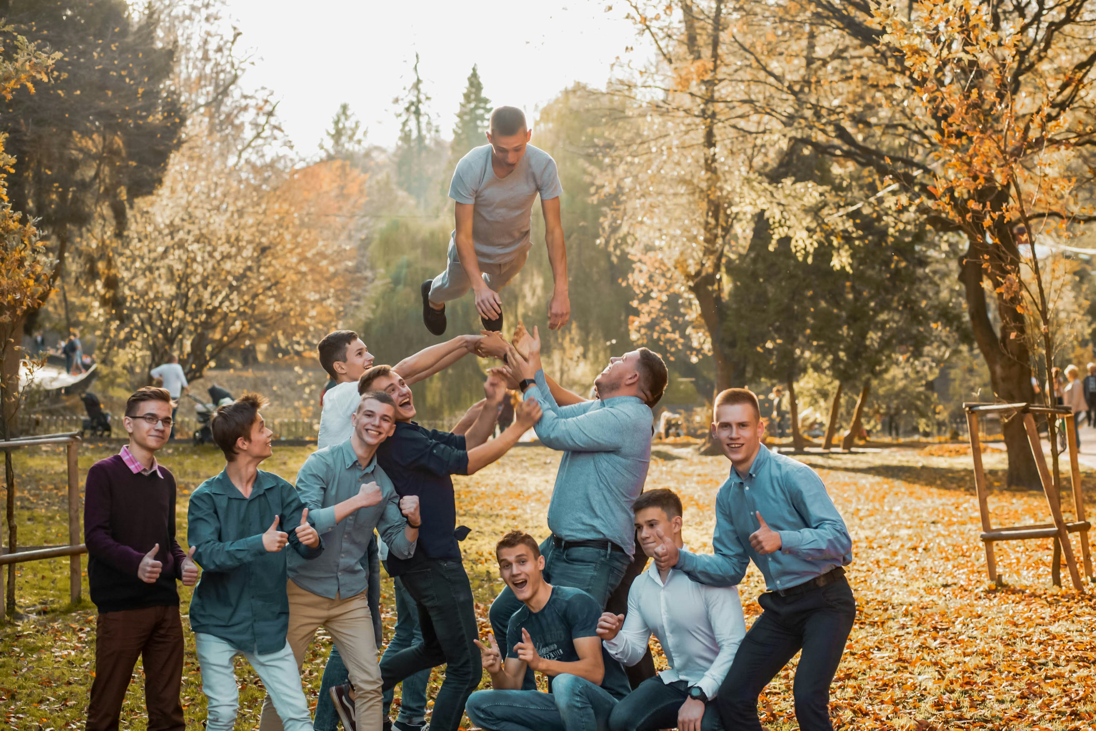 group of people sitting on grass field during daytime