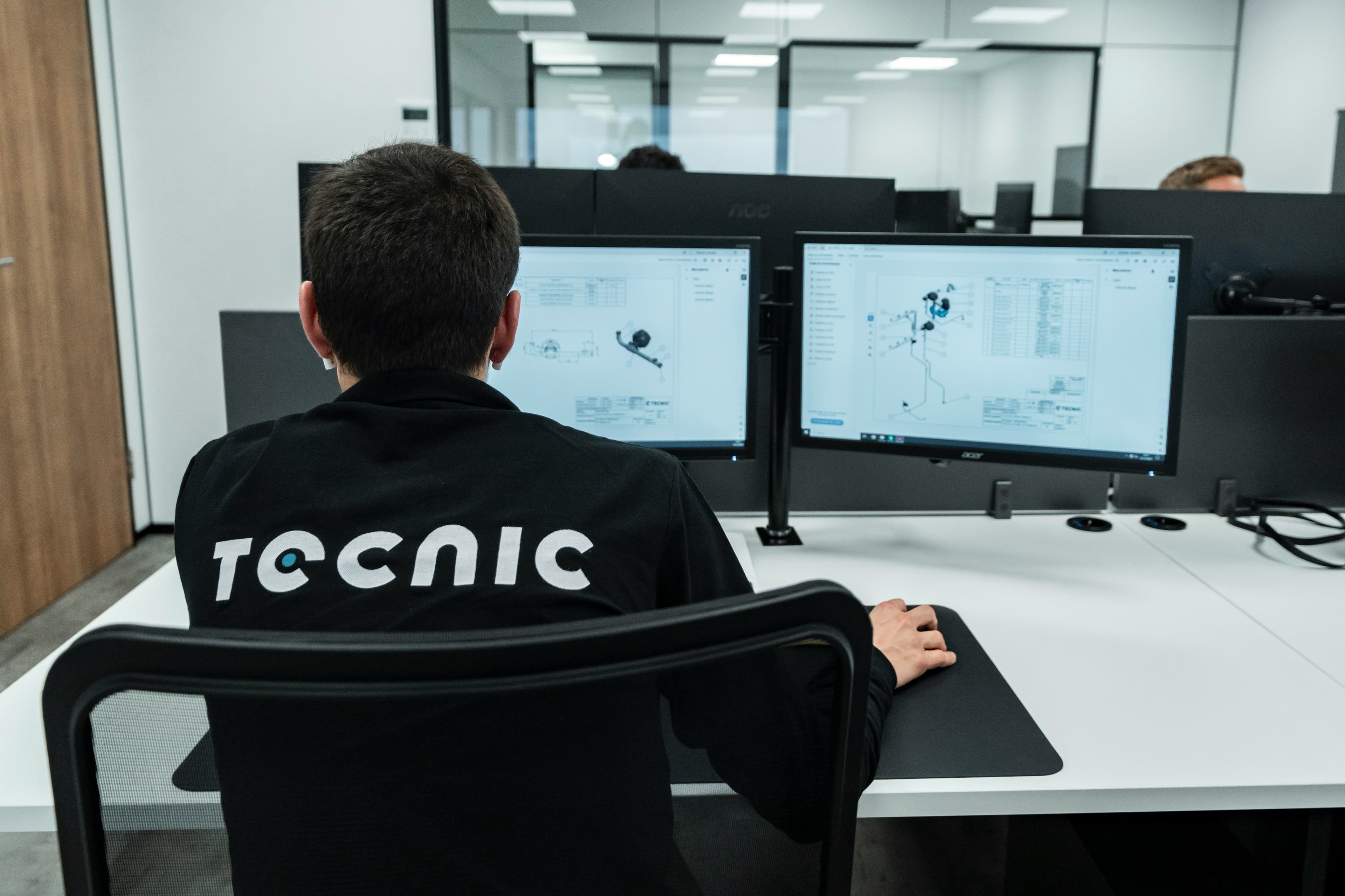 A person works on a computer in an office