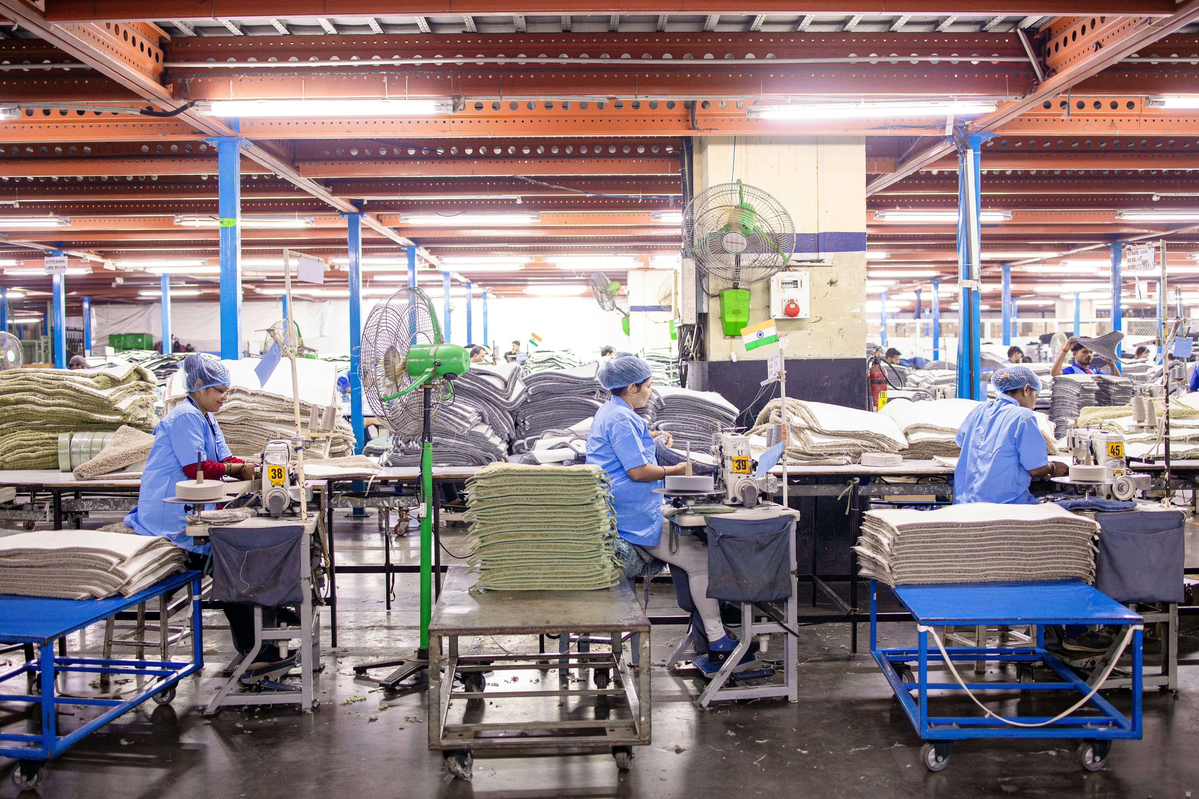 Workers are in an industrial textile manufacturing facility