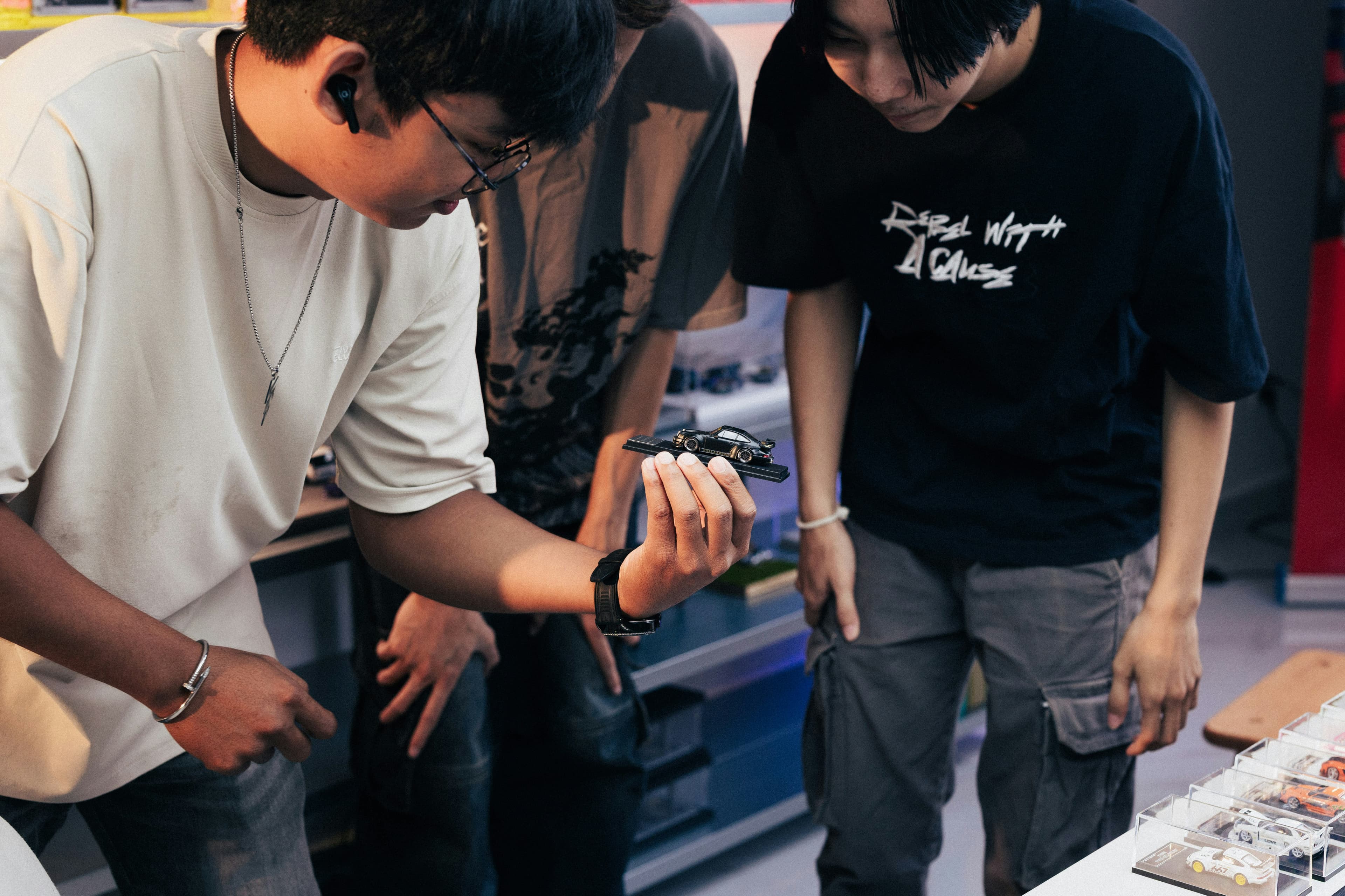 Two people looking at something in a person's hand