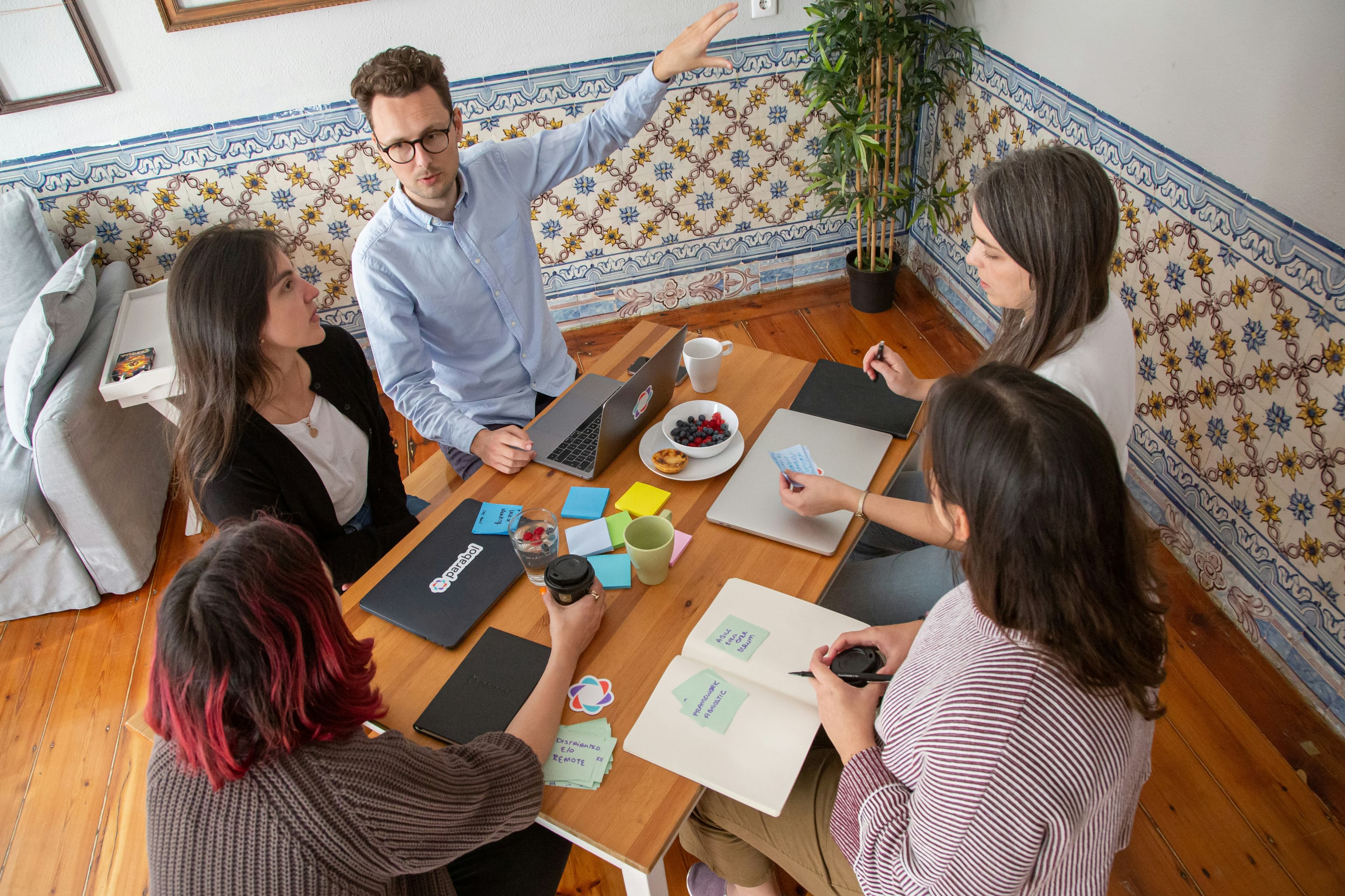 a group of people sitting around a wooden table