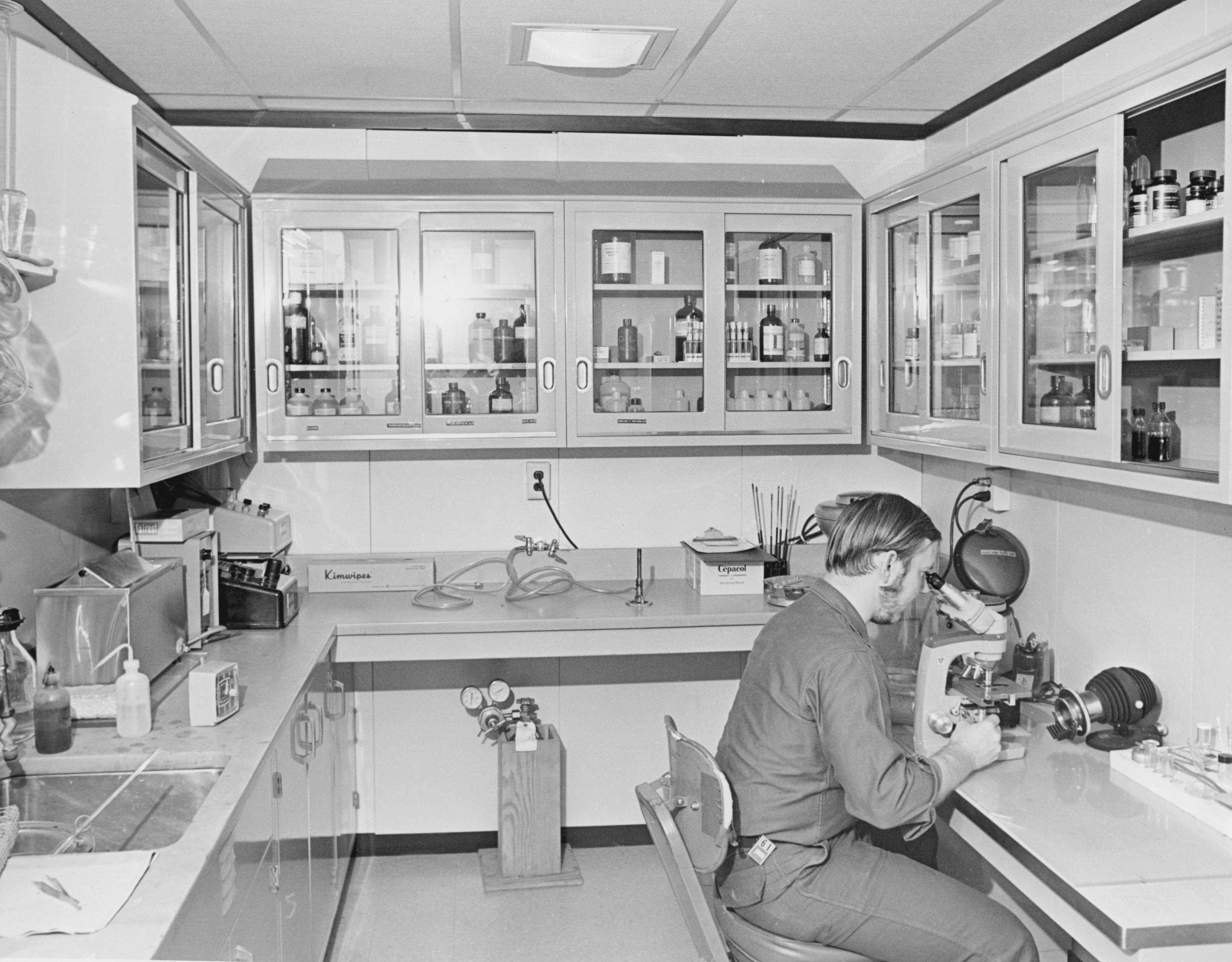 Man working at a microscope in a laboratory